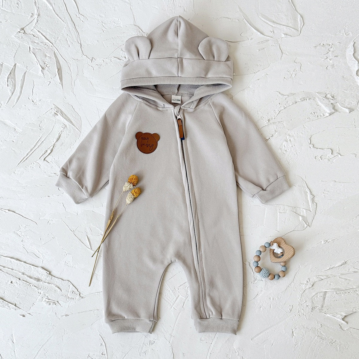 Children's jumpsuit with ears and zipper.
