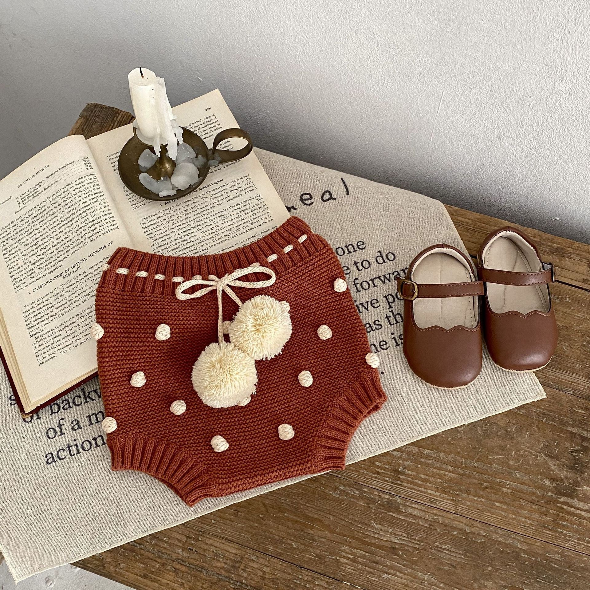 Children's knitted shorts with pompoms.