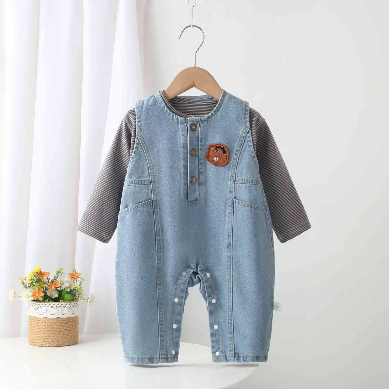 Denim overalls with teddy bear design.