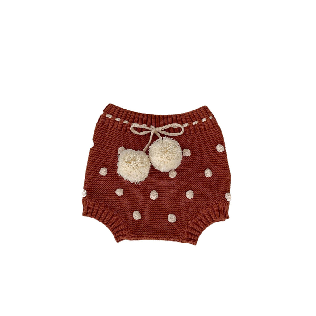 Children's knitted shorts with pompoms.