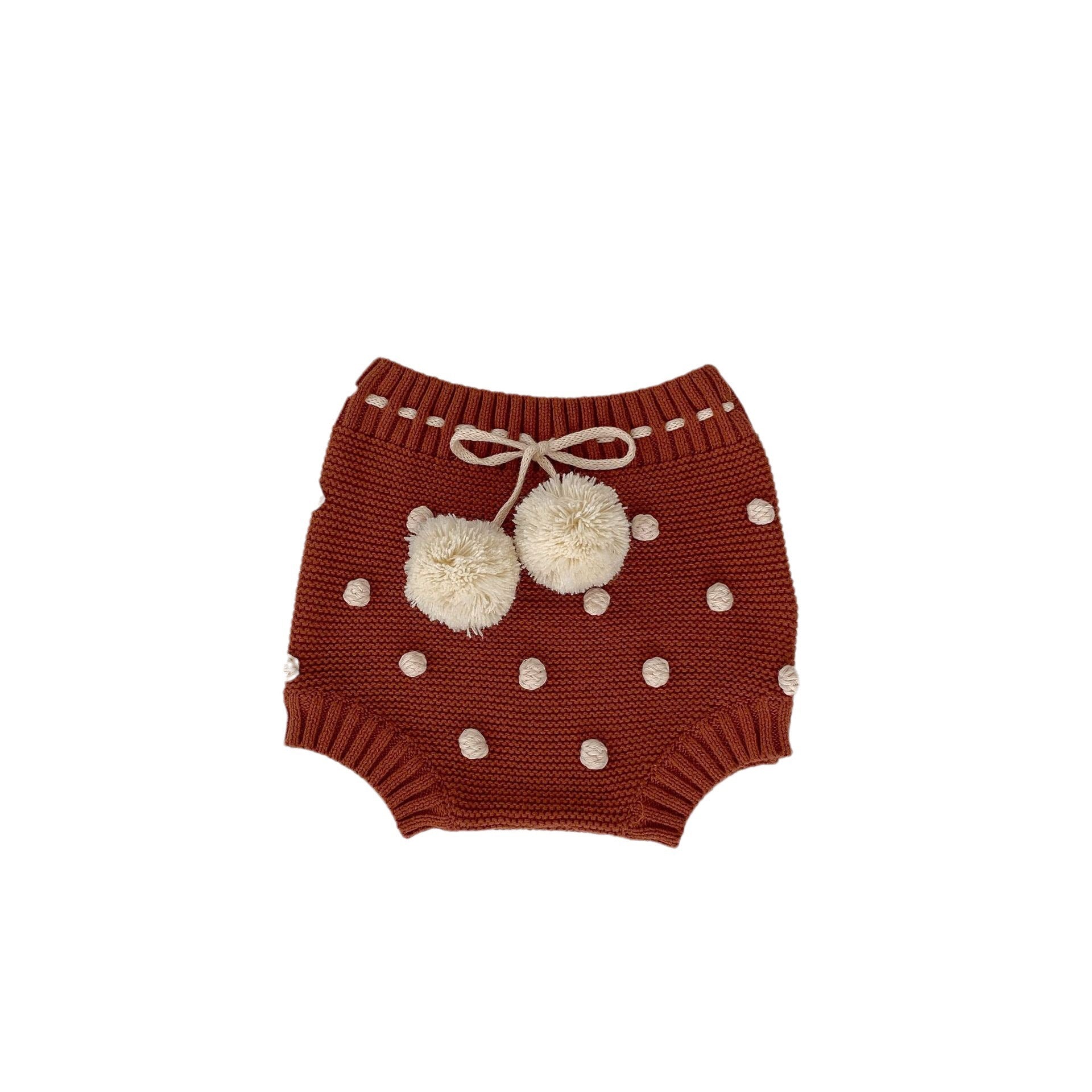 Children's knitted shorts with pompoms.