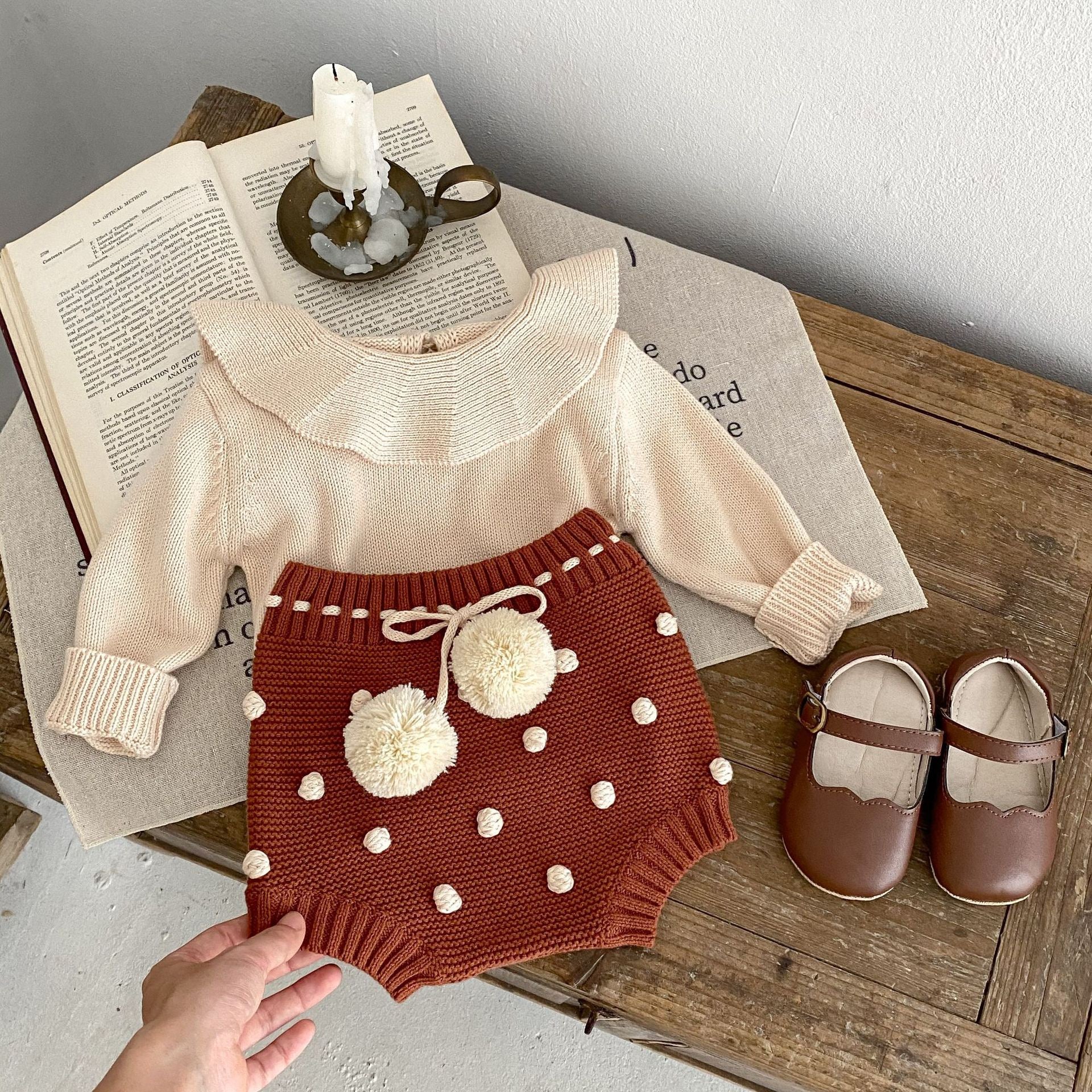 Children's knitted shorts with pompoms.
