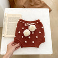Children's knitted shorts with pompoms.