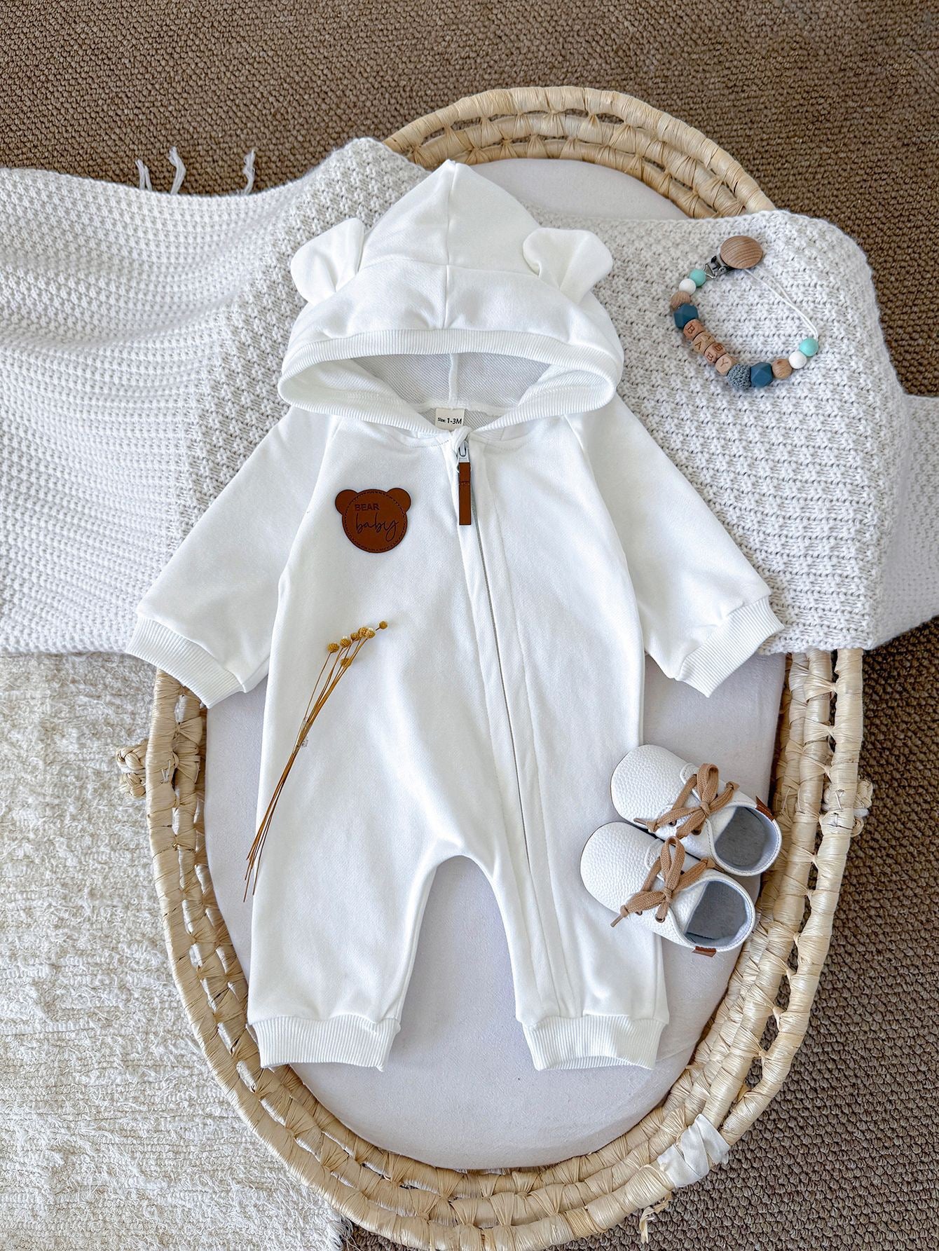 Children's jumpsuit with ears and zipper.