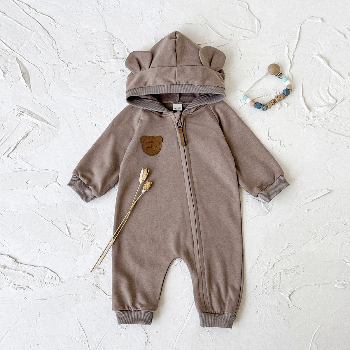 Children's jumpsuit with ears and zipper.