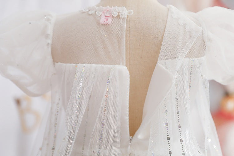 White children's dress with glitter.